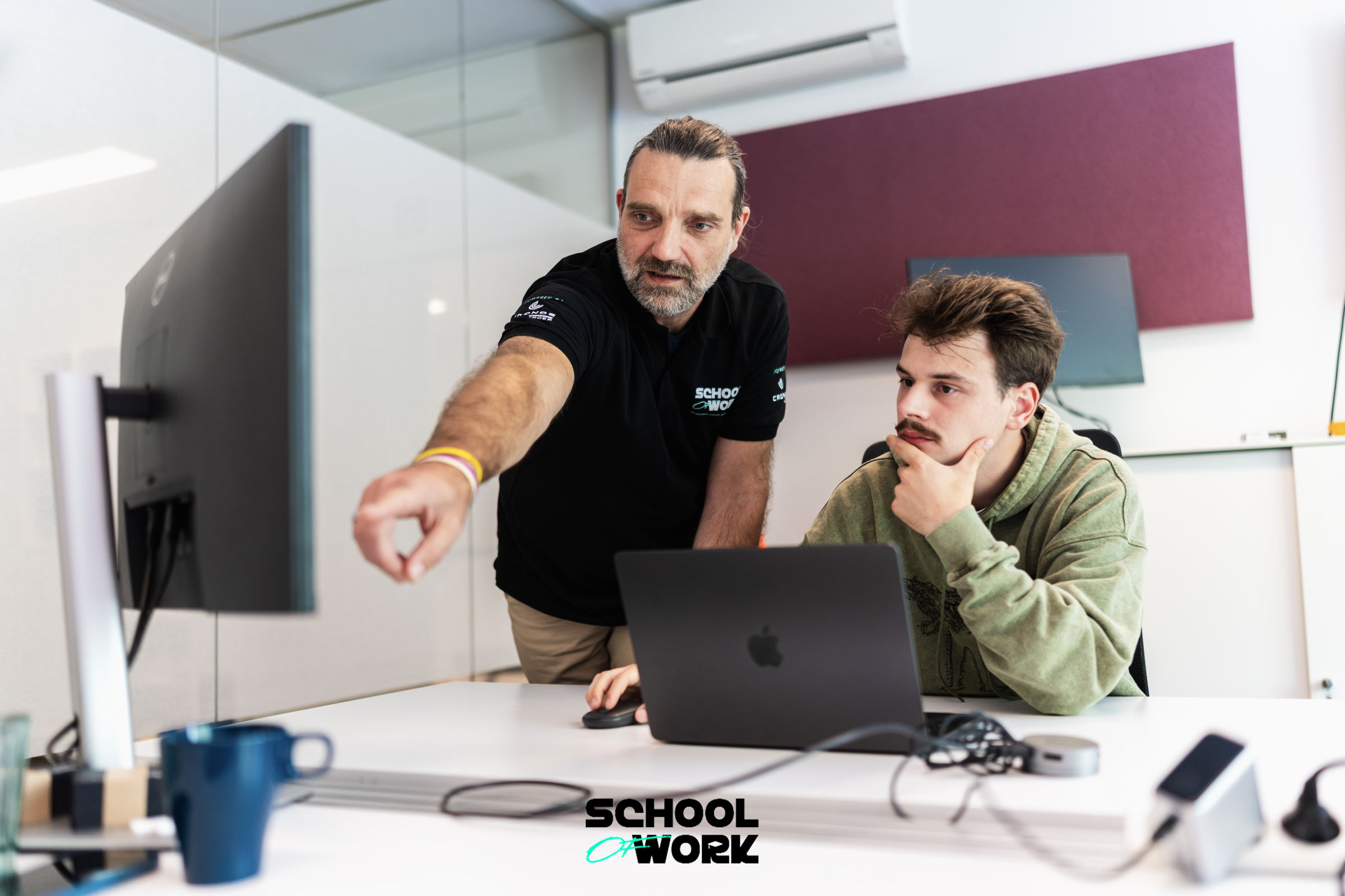 A student and a coach working together at School of Work